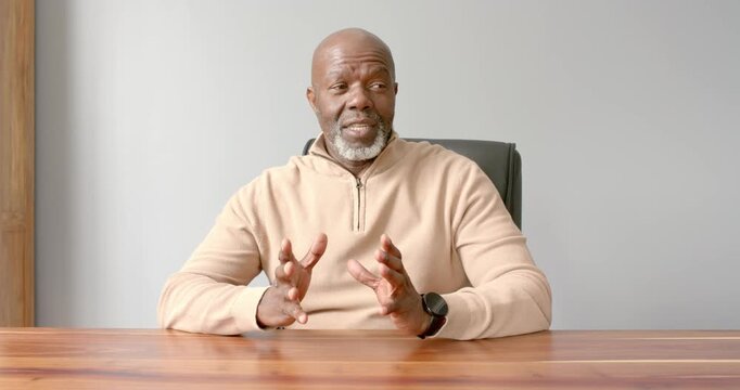 Close up of people talking to the camera, man sitting at desk, explaining with hand gestures, the pe