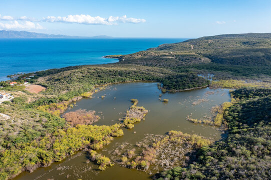 Aerial view of the coastal lagoon and lush vegetation near Playa Monte Rio in Azua, Azua, Dominican Republic.