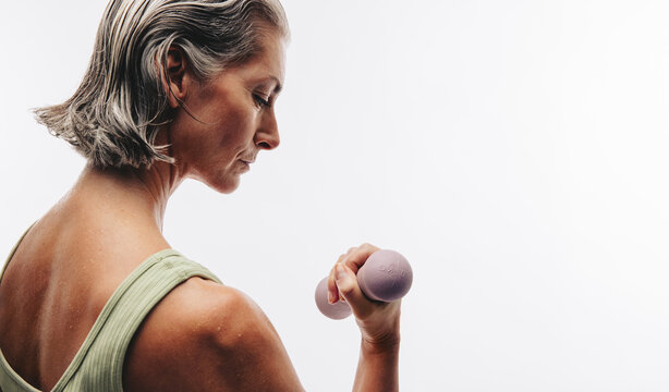 Older woman lifting dumbbell for arm strength