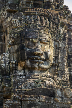 Close up of a smiling giant stone face at Bayon temple in Angkor, Siem Reap, Cambodia