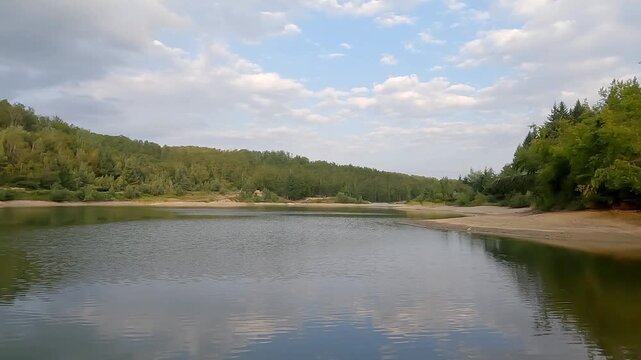 Panning shot of the scenic shoreline and forest at Seliste lake on Goc mountain, Serbia