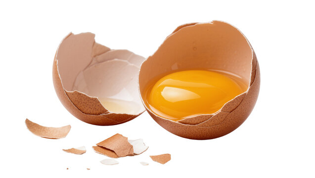 Brown cracked egg with bright yellow yolk and scattered shell pieces, isolated on transparent background