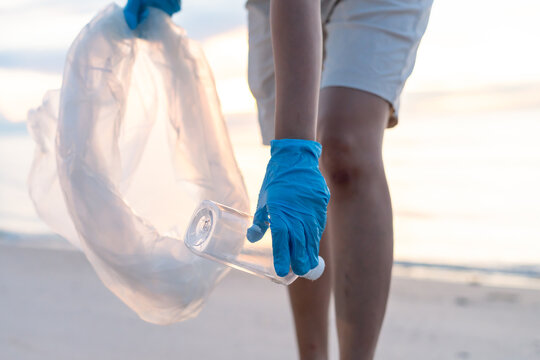 Save water. Volunteer pick up trash garbage at the beach and plastic bottles are difficult decompose prevent harm aquatic life. Earth, Environment, Greening planet, reduce global warming, Save world