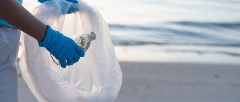 Save water. Volunteer pick up trash garbage at the beach and plastic bottles are difficult decompose prevent harm aquatic life. Earth, Environment, Greening planet, reduce global warming, Save world
