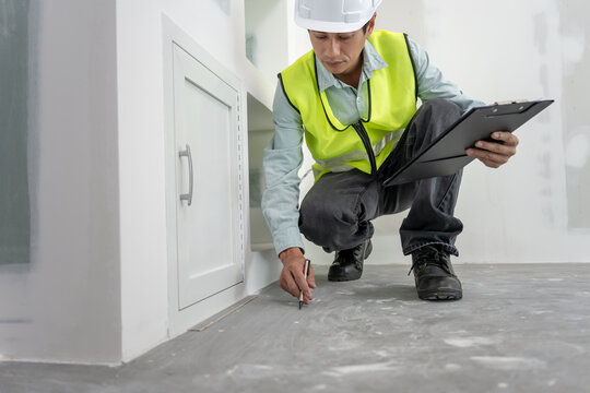 inspector or engineer is inspecting construction and quality assurance new house using a checklist. Engineers or architects or contactor work to build the house before handing it over to the homeowner