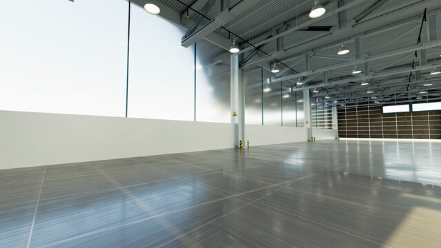 Empty industrial warehouse interior with large windows and high