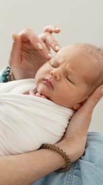 Mom's Hands Gently Caressing Newborn's Head. Vertical video