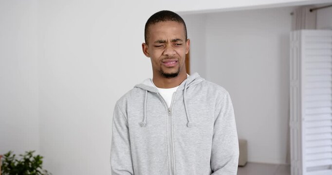 High speed photography for dynamic scenes, looking confused and concerned, man in gray hoodie indoor