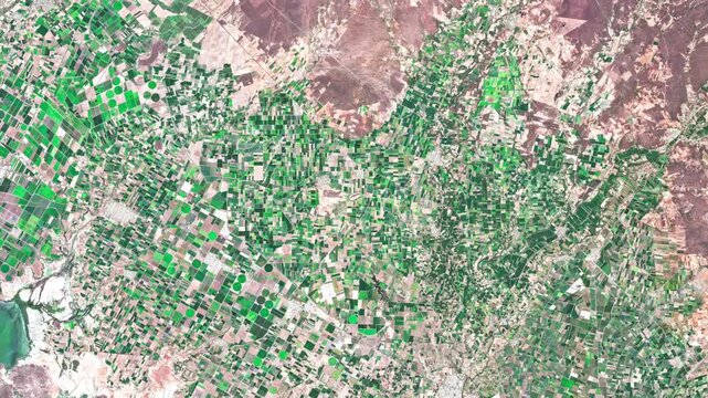 Aerial footage of agricultural land along the Pacific coast in Sinaloa, Mexico, highlighting cultivated fields and the coastal agricultural landscape