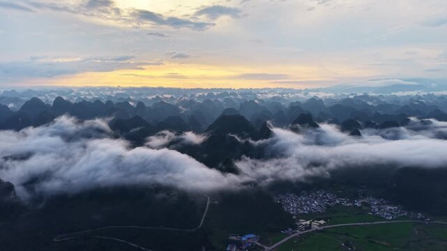 Landscape view: Aerial view of vast rolling clouds over majestic karst mountain peaks