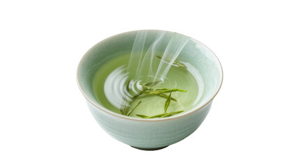 Light green tea leaves steeping in clear liquid in a pale blue ceramic bowl, isolated on...