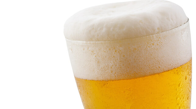 Isolated cold refreshing golden beer in a clear glass with frothy white foam and condensation