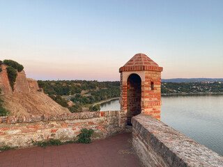 Brick watchtower stands on the ramparts of the Petrovaradin Fortress overlooking the Danube River © lmot11
