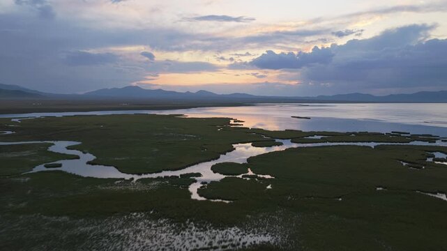 Aerial view of Song Kol Lake at sunset in Kyrgyzstan.