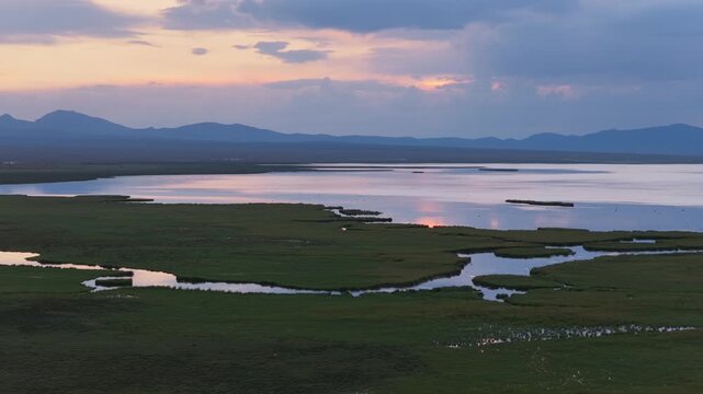 Aerial view of Song Kol lake at sunset in Kyrgyzstan.