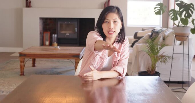 Lifestyle videos indoor of people doing activities at home, Gesturing with hand, woman sitting at ta
