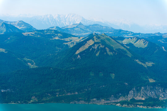 Misty landscape with mountain lake in nature. Mountain peak aerial view. Aerial misty landscape. Scenic nature over lake. Scenic mountain lake. Aerial view of mountain landscape. Landscape panorama