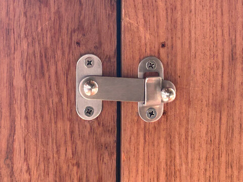 Flip Latch on wooden folding door is closed.