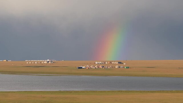 Aerial view of Song Kol Yurt Camp with rainbow in Kyrgyzstan.