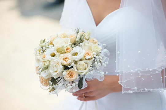 Bride Holding White and Peach Rose Bouquet With Veil Close-Up On Wedding Day