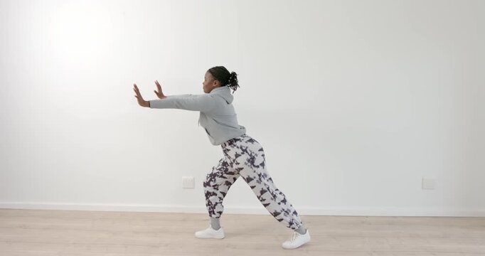 High speed photography for dynamic scenes, Exercising indoors, woman stretching arms and legs in ath