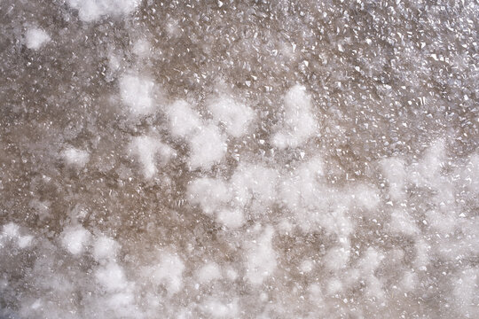  white sea salt crystals forming in evaporation pan at traditional salt marsh