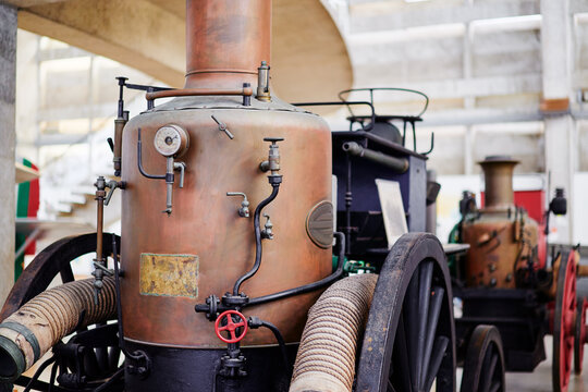 Vintage Steam-Powered Fire Engines Displayed in a Historical Museum Setting