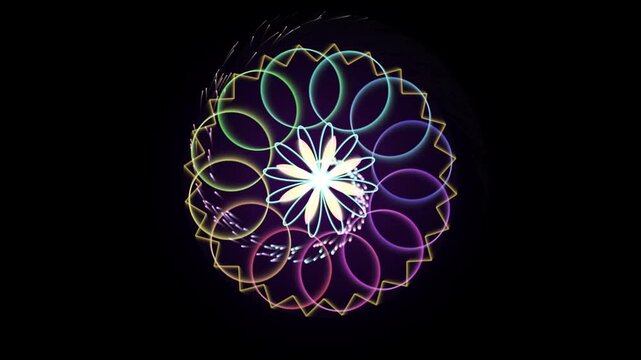 Colorful neon mandala rotating with sparkling particles on black background geometric glowing animation motion graphics abstract kaleidoscope flower pattern symetry light effect sparkles radiant
