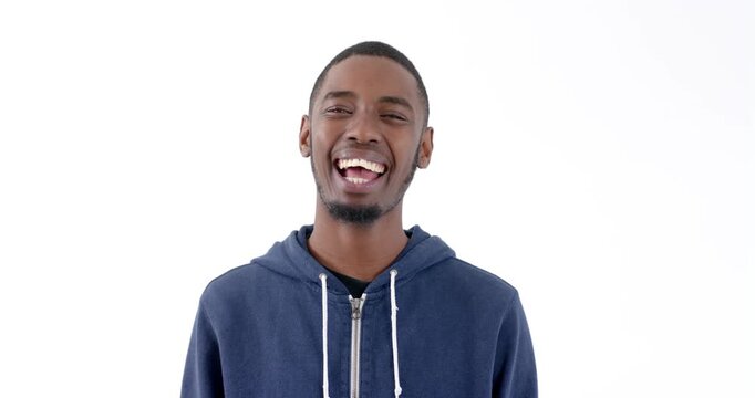 Smiling young man in blue hoodie enjoying moment of laughter