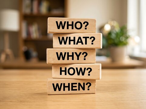 Stacked wooden blocks displaying five question words with question business learning information research strategy