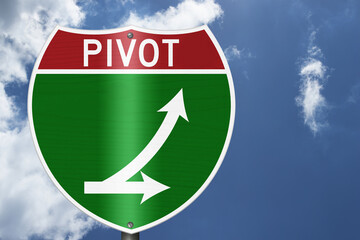 Pivot with arrows on an American interstate road sign with sky for next steps © Karen Roach