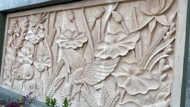 Traditional Stone Relief Carving Featuring Lotus Flower and Birds Motif