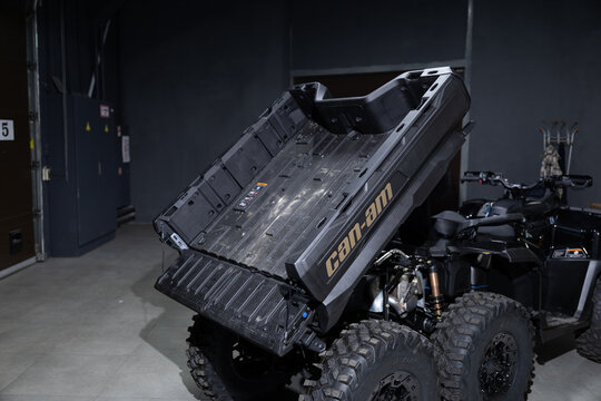 A massive black 6x6 BRP Outlander MAX ATV isolated on a solid black background. Rugged multi-axle design, aggressive stance, heavy-duty build, and sharp studio lighting emphasizing the powerful off-ro