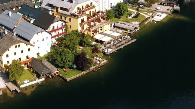 Aerial tilt shot of Hallstatt village and churches in Austria