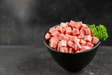 Obraz premium Ham cubed pork cold cuts pork meat delicious appetizer, gourmet dish table setting food background rustic style dish, top view, text space