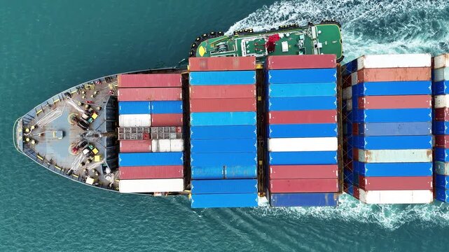 container ship fully loaded with colorful cargo being assisted by a tugboat navigating through the blue ocean. Global maritime logistics and international shipping trade concept