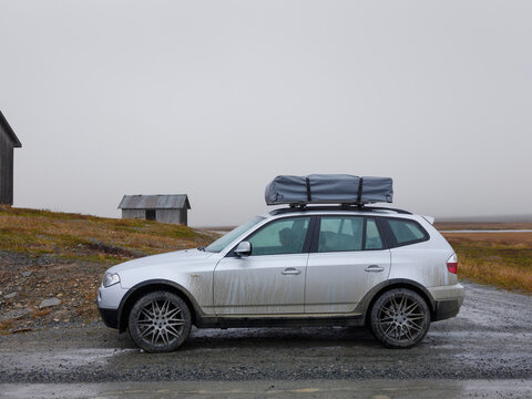 Woman in car on road trip in countryside
