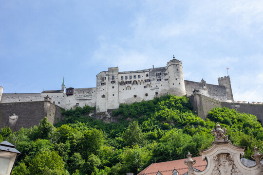 Hohensalzburg Fortress on Festungsberg Hill Framed by Stone Archway in Salzburg, Austria.