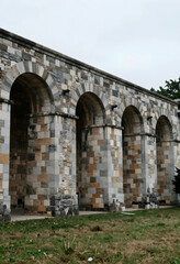 Obraz premium Heritage conservation and historical architecture, stone archway structure with masonry walls and classic design elements in a public park setting