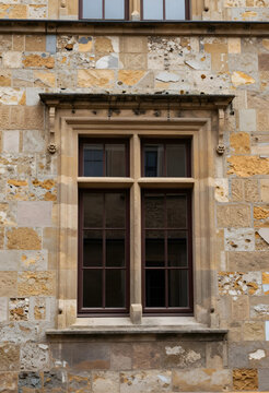 Heritage architecture and historic preservation, stone wall facade with ornate mullioned window in a medieval building exterior for travel background