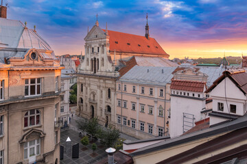Obraz premium Aerial view of Saints Peter and Paul Garrison Church and old town rooftops at dramatic sunset