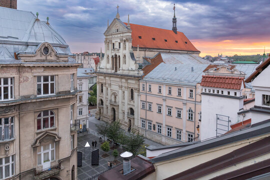 Aerial view of Saints Peter and Paul Garrison Church and old town rooftops at dramatic sunset