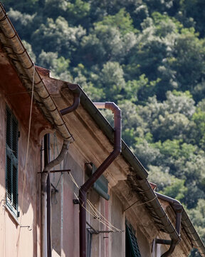 Gutters along the cornice of a row of small apartment buildings