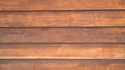 Obraz premium Horizontal lap siding style brown wooden plank background with shadow lines and rich timber texture for exterior architectural designs