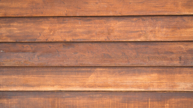 Horizontal lap siding style brown wooden plank background with shadow lines and rich timber texture for exterior architectural designs