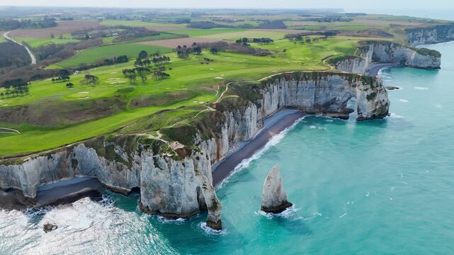 Etretat chalk cliffs, natural arches and Aiguille d Etretat in Normandy, France. Aerial footage of famous coastal rock formations
