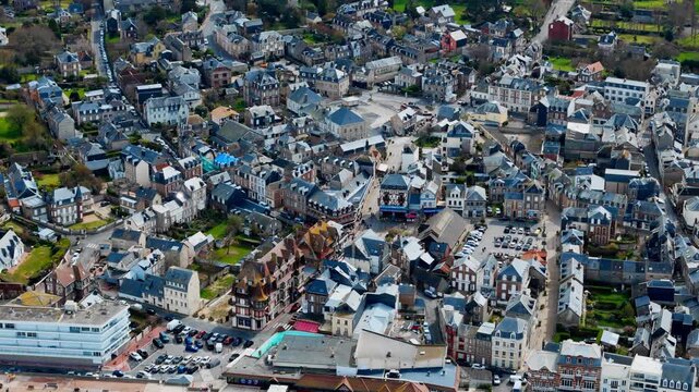 Rooftops and streets of Etretat, Normandy, France. Aerial footage of coastal town with traditional houses and half-timbered architecture.