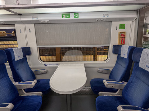 Przemysl, Poland - March 3, 2026: Blue passenger seats with a central table inside a modern railway train carriage for comfortable travel and convenient intercity commute service
