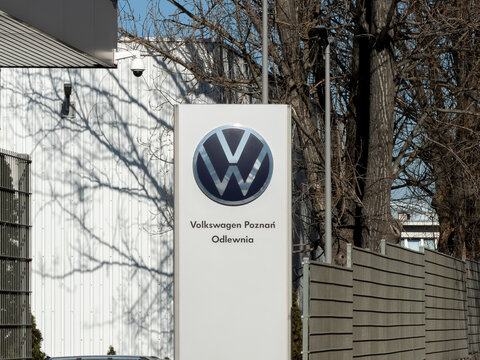 Poznan, Poland - March 6, 2026: Volkswagen signage at the foundry facility entrance stands outdoors near a tall security fence, reflecting the industrial presence of the motor company