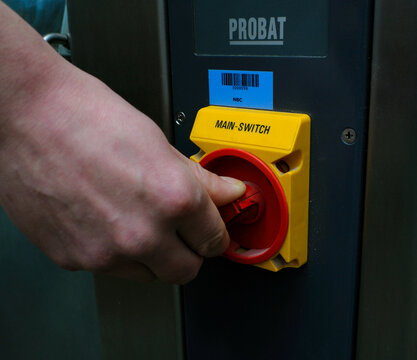 Hand turning the main power switch on Probat bakery machinery. September 15, 2019. Kyiv, Ukraine